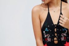09 a black lace up one piece swimsuit with floral embroidery and star appliques is a fun idea