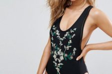 10 a black one piece swimsuit with a deep cut and floral embroidery plus deep side cuts for a sexy feel