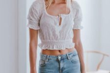 11 a beautiful look with blue ripped jeans, a white feminine linen crop top, a straw bag