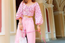 11 a pink floral print crop top with bell sleeves, pink cropped jeans and pink mules plus a white crochet bag