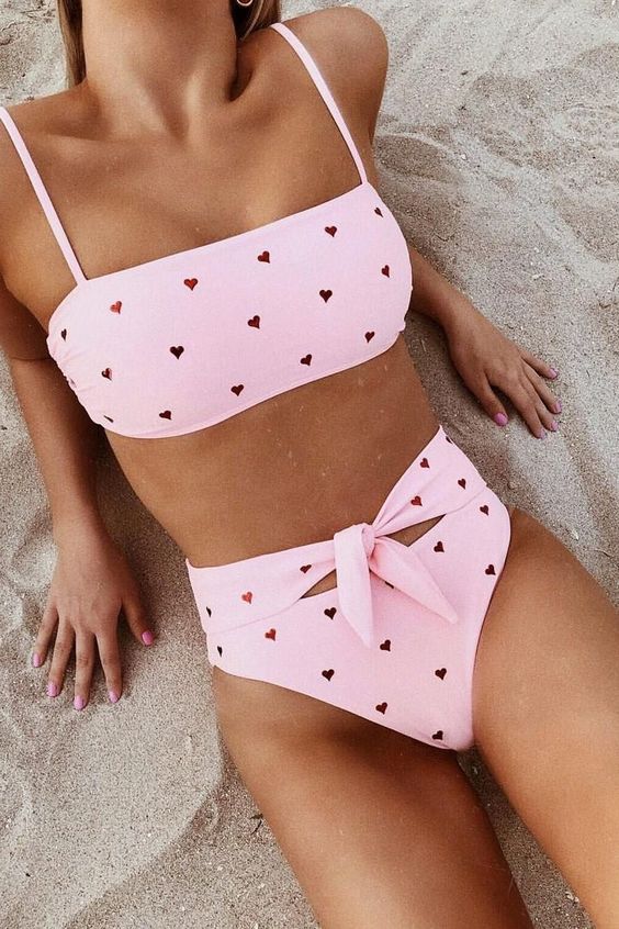 a pink embellished bikini with a spaghetti strap top and a high waisted bottom with a knot detail