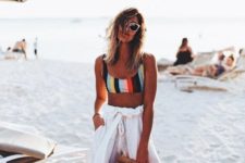 13 a sexy look with a croloful striped bikini top, white high waisted pants and a wooden bag