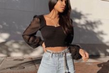 13 a sexy outfit with blue high waisted jeans and a black square neckline blouse with sheer long sleeves