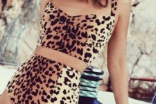 15 a retro-inspired animal print bikini with a long top and a high waisted bottom plus statement earrings and a fringe hat