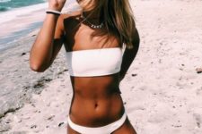 15 a stylish minimalist bikini in white with a bandeau top and a usual bottom is beach basics