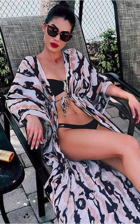 an abstract print beach kimono perfectly matches the black bikini and makes it look cooler