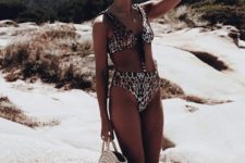 16 a vintage inspired beach look with a leopard bikini, a top on ties and a high waisted bottom plus s round straw bag