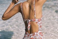 16 a vintage-inspired floral one piece swimsuit with spaghetti straps, a cutout back and a knot