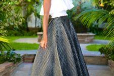 With A-line maxi skirt and black and golden high heels
