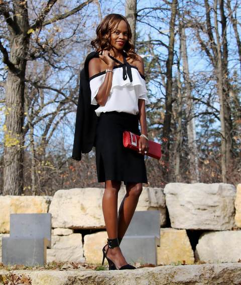 With black skirt, red clutch, ankle strap shoes and blazer