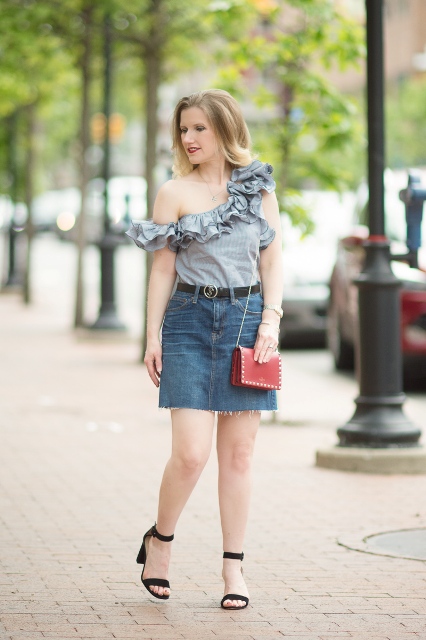 With denim mini skirt, red mini bag and black ankle strap sandals
