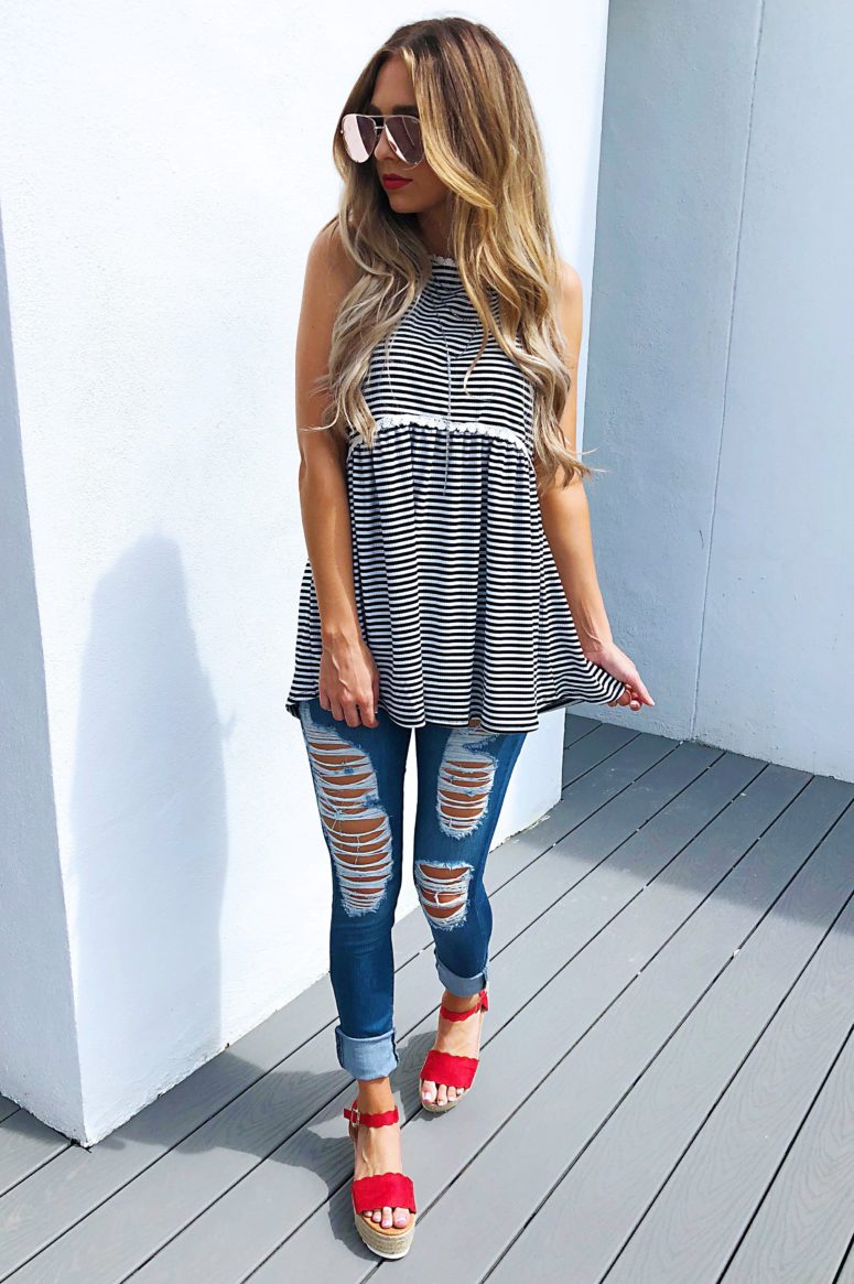 With distressed jeans and red platform sandals