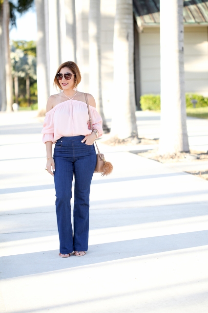 With flare jeans, beige bag and high heels