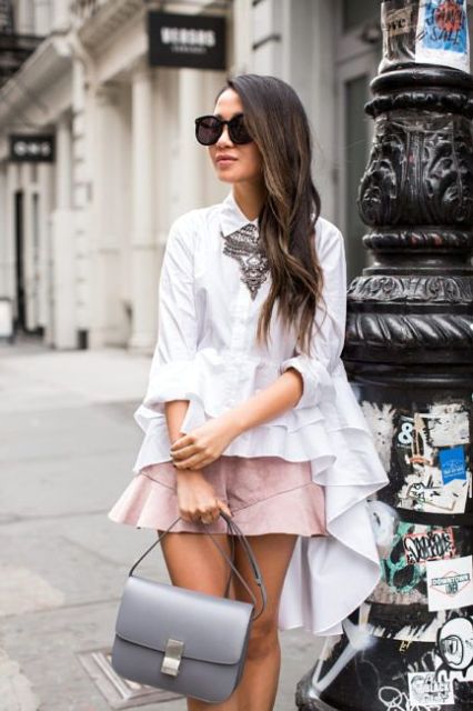 With white ruffled shirt, gray bag and necklace