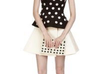With white skirt, polka dot clutch and ankle strap high heels