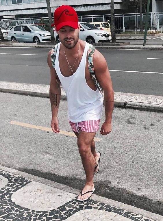 a white t shirt, pink and white vertical stripe swim trunks and flipflops to go to the beach