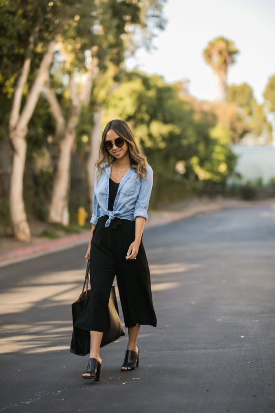 a black culotte jumosuit, black heels, a chambray shirt and a black tote - take off the shirt and get to work
