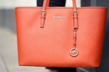 04 a bright orange laptop tote with a simple and elegant design will make a statement with its color