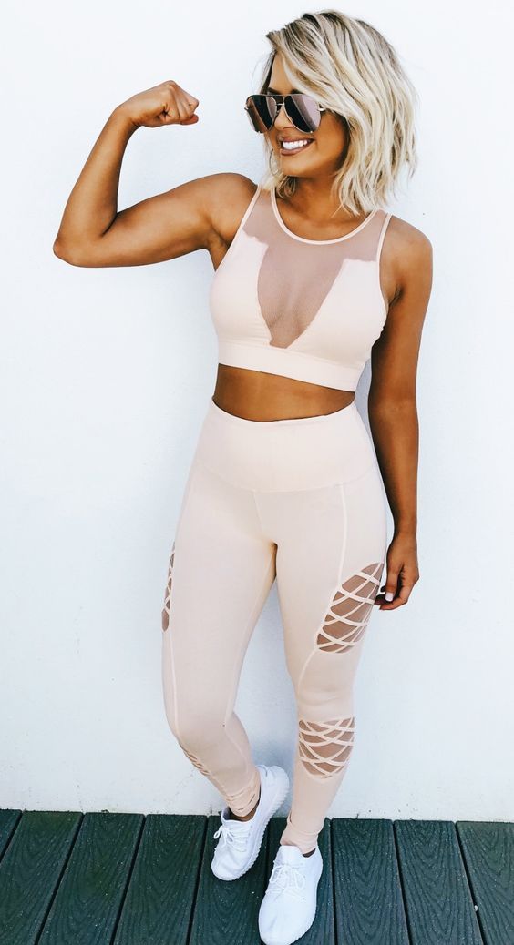 a sexy blush set with an illusion neckline sleeveless top, cutout leggings and white trainers