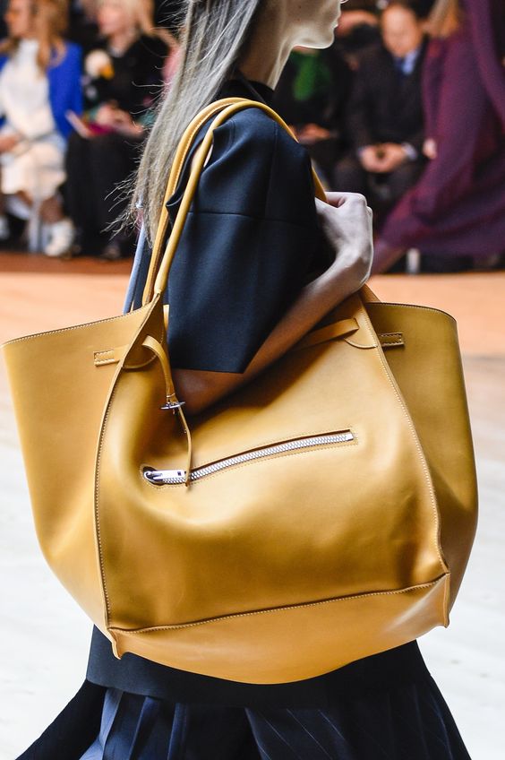 a super large catch all bag in sunny yellow will make a statement in your look with both its size and color