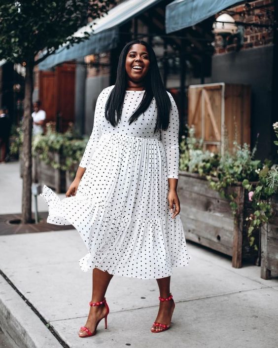 a white A-line polka dot midi dress and red shoes for a bold yet romantic office look