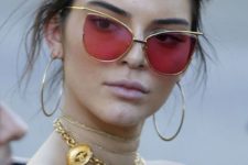 12 Kendall Jenner rocking red sunglasses with thin gold frames and a totally unique shape