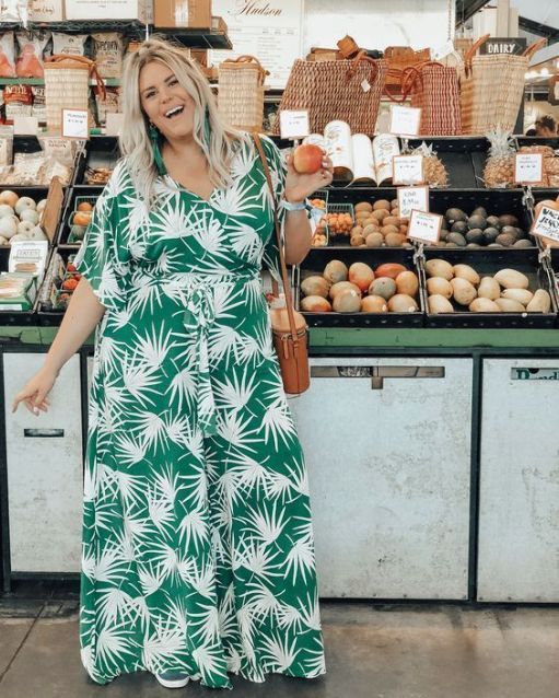 a green tropical print maxi wrap dress, statement earrings and a bucket bag for a summer party