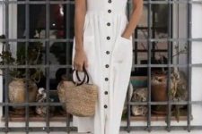 14 a white midi dress with black buttons, pockets and short sleeves, black strappy sandals and a straw bag