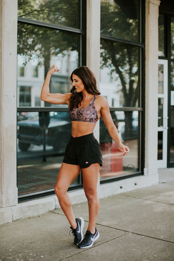 black shorts, an animal print sport bra and black trainers for active summer workouts