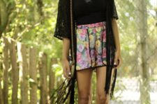 With floral high-waisted shorts, black shirt, hat, chain strap bag and lace up sandals