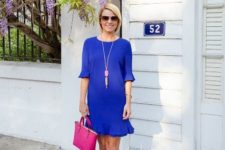With hot pink small bag and beige pumps