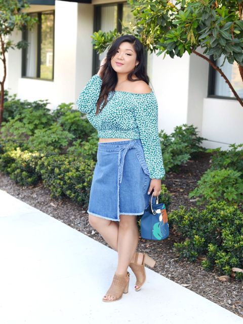 With printed off the shoulder blouse, blue bag and beige heels