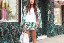 With white loose top, tropical shorts, white bag and black flat shoes