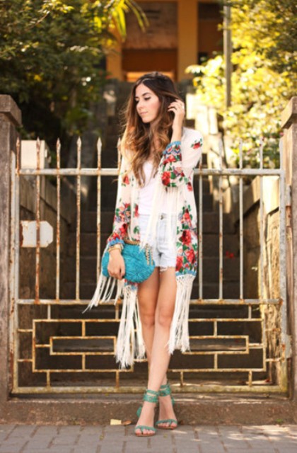 With white shirt, shorts, ankle strap high heels and clutch