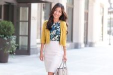 With yellow cardigan, white pencil skirt, gray bag and gray shoes