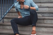 a blue chambray shirt, black rolled up pants, brown slipons make up a stylish and comfortable outfit