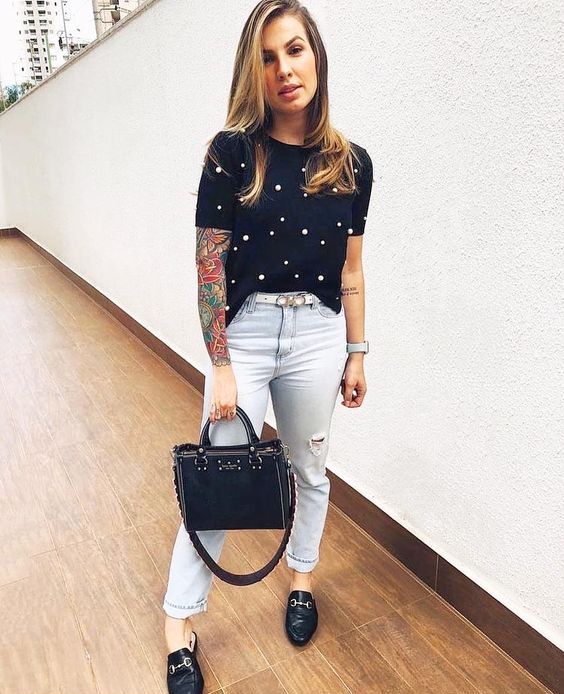 a chic look with bleached ripped jeans, a black pearl tee, black loafers and a black bag