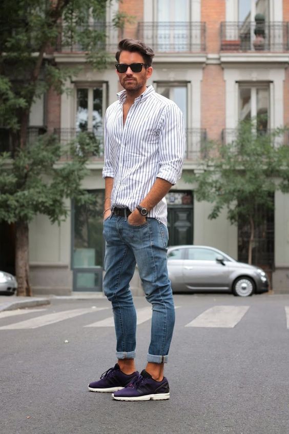 a classic strpied shirt, blue jeans and purple sneakers for a touch of color in the outfit