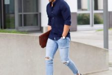 a navy shirt, blue ripped jeans and black slipons for a casual transitional look