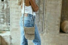 bleached baggy jeans, a white top, a wucker bag and brown slippers for a comfortable summer look