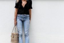 bleached jeans with a raw hem, a black shirt with short sleeves, nude sandals and a wicker basket bag