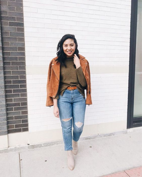 a brown turtleneck, blue ripped jeans, nude boots and an amber moto jacket for an effortlessly cool look