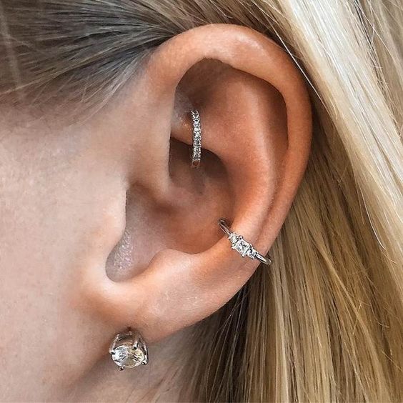 a double conch piercing with shiny rhinestone hoops is a bright and chic idea to rock