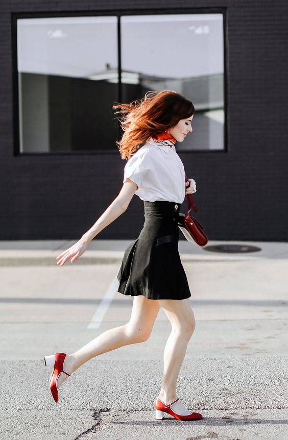 a white shirt, a black high waisted skirt, red Mary Jane shoes and a matching bag for the fall