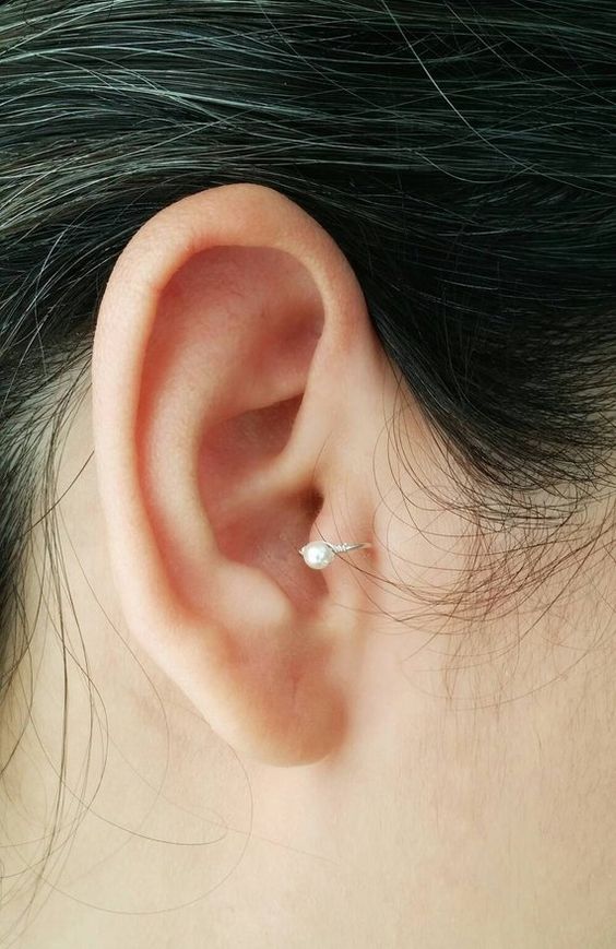 a shiny pearl hoop earrings in the tragus is a stylish idea - no other piercings here