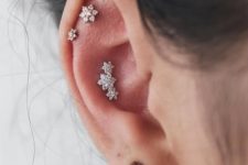 06 shiny floral studs in the daith, conch and a simple and stylish stud in the lap
