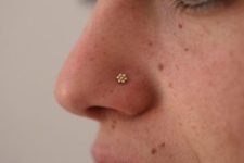 10 a tiny gold floral piercing for a girly touch and a bling on your face
