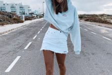 12 a grey hoodie, a white denim mini skirt with a raw hem and black sneakers