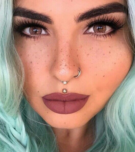 a gorgeous double nose hoop piercing and an additional spetum ring for a super rebellious look