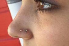 13 double gold nose piercing will accent your face a lot, choose bold studs for a brighter look